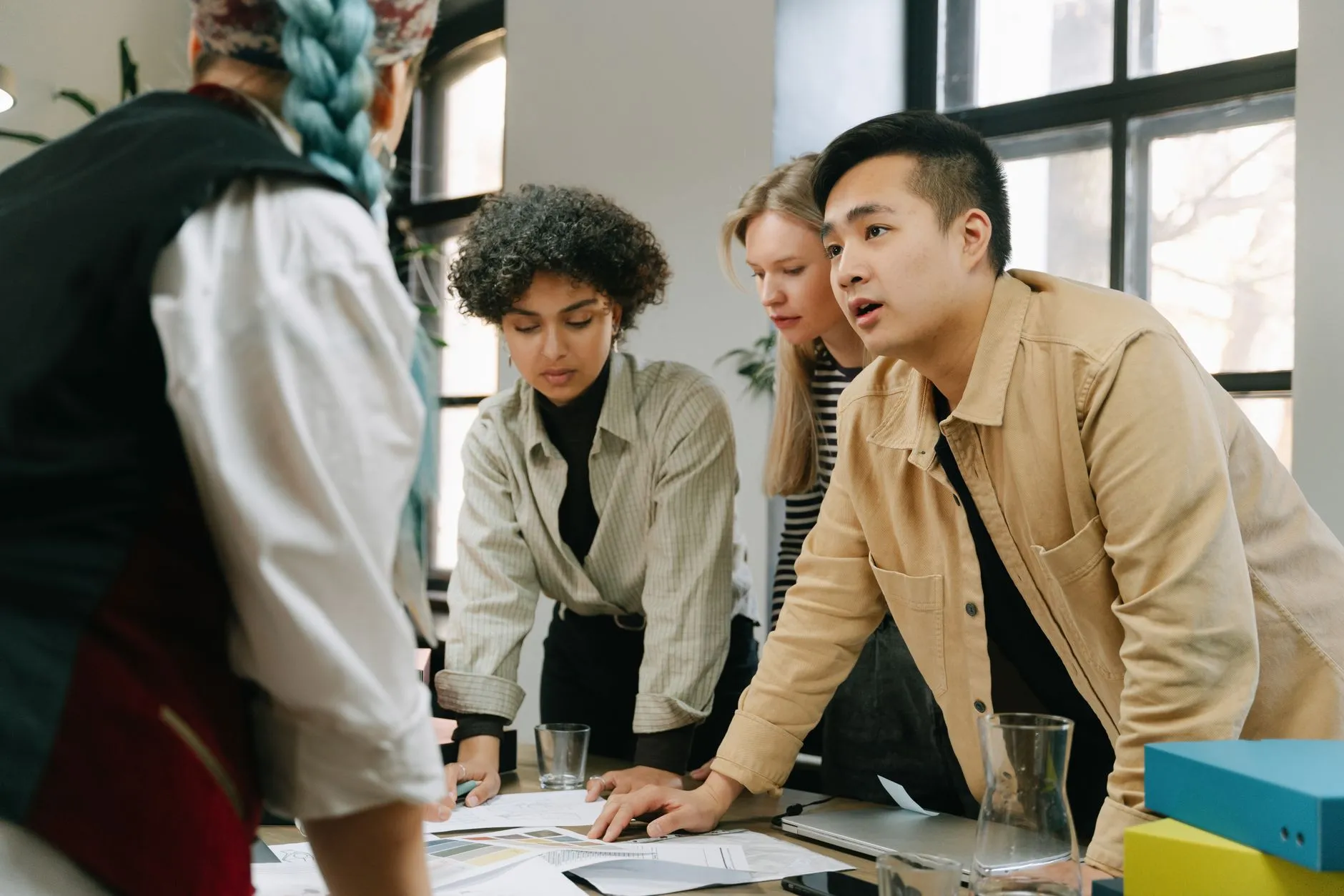 Colleagues working through paperwork together at a table