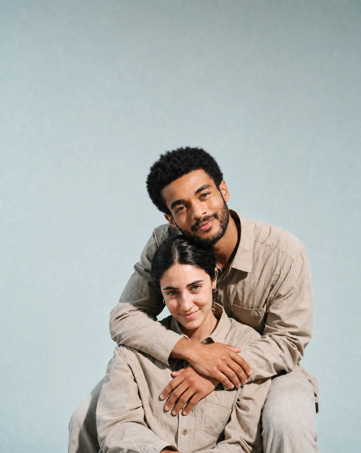 A couple sitting close together, smiling